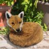 Detailed curled up fox figurine showing realistic fur texture and design